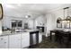 Open-concept kitchen with granite countertops and stainless steel appliances flows into the adjacent living area at 60 Falling Leaf Ln, Benson, NC 27504
