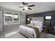 Well-lit main bedroom features a panel accent wall, plush carpet, and large window for natural light at 60 Falling Leaf Ln, Benson, NC 27504