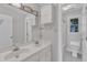Well-lit bathroom features a double sink, storage cabinets, and a view into a second bathroom area at 6201 Bayswater Trail Trl, Raleigh, NC 27612