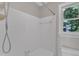 Clean bathroom featuring white tile walls and a window that lets in natural light at 6201 Bayswater Trail Trl, Raleigh, NC 27612