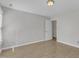 Bright bedroom featuring neutral walls, wood floors, and a door that leads to another room at 6201 Bayswater Trail Trl, Raleigh, NC 27612