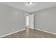 Bright bedroom featuring neutral walls, wood floors, and a door that leads to another room at 6201 Bayswater Trail Trl, Raleigh, NC 27612