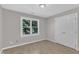 Neutral bedroom with wood floors, a double door closet, and a window at 6201 Bayswater Trail Trl, Raleigh, NC 27612