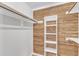 Walk-in closet is finished with cedar plank backing and bright white shelves and clothing rods at 6201 Bayswater Trail Trl, Raleigh, NC 27612