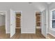 Bedroom showing two walk-in closets with cedar plank backing and bright storage shelves at 6201 Bayswater Trail Trl, Raleigh, NC 27612