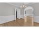 Bright dining room with hardwood floors, chair rail, and elegant chandelier lighting at 6201 Bayswater Trail Trl, Raleigh, NC 27612