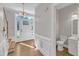 Light-filled entryway with hardwood floors, staircase, and adjacent half-bath at 6201 Bayswater Trail Trl, Raleigh, NC 27612