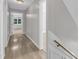 Hallway with hardwood floors leads to another room and has a staircase with white risers at 6201 Bayswater Trail Trl, Raleigh, NC 27612