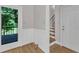 Hallway leading to outdoor deck and stairs to second floor with paneled walls at 6201 Bayswater Trail Trl, Raleigh, NC 27612