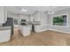 Spacious kitchen featuring white cabinets, granite countertops, island, and eat-in breakfast area at 6201 Bayswater Trail Trl, Raleigh, NC 27612