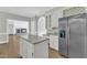 Open concept kitchen with granite island, stainless appliances, and seamless flow to living spaces at 6201 Bayswater Trail Trl, Raleigh, NC 27612