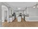 Open kitchen features an island, stainless appliances, granite counters, and white cabinetry at 6201 Bayswater Trail Trl, Raleigh, NC 27612