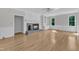 Inviting living room with a beautiful fireplace, built-in shelves, and light hardwood floors at 6201 Bayswater Trail Trl, Raleigh, NC 27612