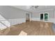 Spacious living room with white wainscoting, hardwood floors, and access to the outdoors at 6201 Bayswater Trail Trl, Raleigh, NC 27612