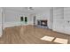 Bright living room with fireplace, built-ins, and french doors that bring the outdoors in at 6201 Bayswater Trail Trl, Raleigh, NC 27612