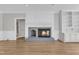 Cozy living room showing fireplace with classic detailing and hardwood flooring at 6201 Bayswater Trail Trl, Raleigh, NC 27612