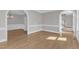 Open-concept room showcasing hardwood floors, archways, and abundant natural light at 6201 Bayswater Trail Trl, Raleigh, NC 27612