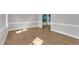 An empty living room with hardwood floors, fresh paint, and natural light at 6201 Bayswater Trail Trl, Raleigh, NC 27612
