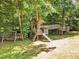 Backyard playset with slides, bridges, swings, and a small tree house at 6328 Jones Farm Rd, Wake Forest, NC 27587