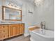 Luxurious bathroom featuring a soaking tub and a wooden vanity at 6328 Jones Farm Rd, Wake Forest, NC 27587