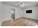 Bedroom with hardwood floors, ceiling fan, and access to the laundry room at 6328 Jones Farm Rd, Wake Forest, NC 27587