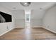 Bright bedroom featuring wood floor, angled walls, and large window bringing in natural light at 6328 Jones Farm Rd, Wake Forest, NC 27587