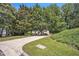 Home with long driveway and surrounded by mature trees in a large yard at 6328 Jones Farm Rd, Wake Forest, NC 27587