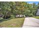 Home with driveway and trees in a large yard with a purple front door at 6328 Jones Farm Rd, Wake Forest, NC 27587