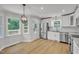 Modern kitchen with white cabinets, stainless steel appliances, and an eat-in area near the back door at 6328 Jones Farm Rd, Wake Forest, NC 27587