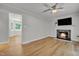 Inviting living room with a fireplace, ceiling fan, and hardwood floors at 6328 Jones Farm Rd, Wake Forest, NC 27587