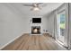 Inviting living room with wood flooring, a cozy fireplace, and a large window for natural light at 6328 Jones Farm Rd, Wake Forest, NC 27587