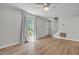 Bright living room with wood floors, neutral paint, large window, and white trim at 6328 Jones Farm Rd, Wake Forest, NC 27587