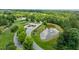 Aerial view showcases landscaped entrance to community with pond and fountain at 74 Permit Ct, Chapel Hill, NC 27517