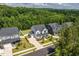 Community homes surrounded by mature trees, showcasing the neighborhood's scenic beauty at 74 Permit Ct, Chapel Hill, NC 27517
