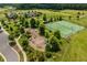 Aerial view of community playground, tennis courts, green space, and walking paths at 74 Permit Ct, Chapel Hill, NC 27517