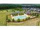 An aerial shot showcases a luxurious community pool with beautiful landscaping and clubhouse amenities at 74 Permit Ct, Chapel Hill, NC 27517
