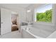 Bathroom featuring a soaking tub with a large window view at 74 Permit Ct, Chapel Hill, NC 27517