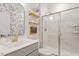 Elegant bathroom with a glass-enclosed shower, floating shelves, and stylish floral wallpaper at 74 Permit Ct, Chapel Hill, NC 27517