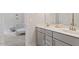 Bright bathroom featuring double vanity, a baby crib, and neutral color palette at 74 Permit Ct, Chapel Hill, NC 27517