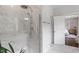 Walk-in shower featuring a rainfall shower head, marble tiling, and glass door at 74 Permit Ct, Chapel Hill, NC 27517