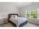 Bedroom with a queen sized bed, two side tables, and natural light at 74 Permit Ct, Chapel Hill, NC 27517