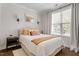 Cozy bedroom with a queen-sized bed, accent lighting, and large windows for natural light at 74 Permit Ct, Chapel Hill, NC 27517