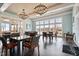 The interior of the clubhouse is well lit by chandeliers and large windows overlooking the pool at 74 Permit Ct, Chapel Hill, NC 27517