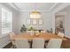 Dining room with a large wooden table, modern chairs, and an elegant chandelier at 74 Permit Ct, Chapel Hill, NC 27517