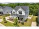 Stunning aerial view of a modern home with lush landscaping and a well-manicured lawn at 74 Permit Ct, Chapel Hill, NC 27517