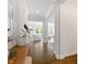 Bright foyer showcasing hardwood floors, white trim, and an inviting view into the living spaces at 74 Permit Ct, Chapel Hill, NC 27517