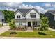 Charming two-story home with stone accents, manicured lawn, and a welcoming front porch at 74 Permit Ct, Chapel Hill, NC 27517