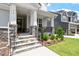 Inviting front porch with stone steps and iron railing, perfect for relaxing outdoors at 74 Permit Ct, Chapel Hill, NC 27517