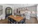 Stylish kitchen with gray cabinets, stainless steel appliances, island seating, and adjacent dining area at 74 Permit Ct, Chapel Hill, NC 27517