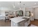 Modern kitchen featuring stainless appliances, gray cabinetry, quartz counters, and an open floor plan at 74 Permit Ct, Chapel Hill, NC 27517